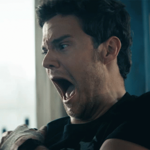 A Man Making A Funny Face With His Mouth Wide Open GIF