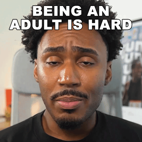 A Man Making A Funny Face With The Words Being An Adult Is Hard Written Above Him GIF
