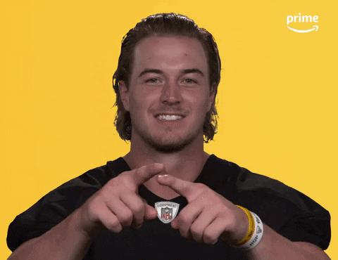 A Man Making A Heart Shape With His Hands In Front Of An Amazon Prime Logo GIF