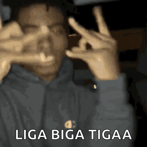 A Man Making A Peace Sign With His Hands And The Words Liga Biga Tigaa GIF