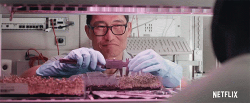 A Man Measuring A Piece Of Food With A Netflix Logo In The Background GIF