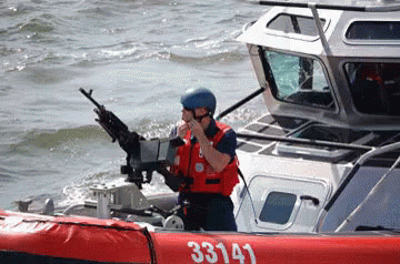 A Man On A Boat With The Number 33143 On The Side Of It GIF