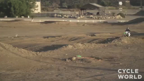 A Man On A Dirt Bike Is Doing A Trick In The Air . GIF