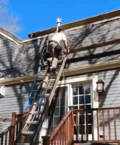 A Man On A Ladder Working On A Roof GIF