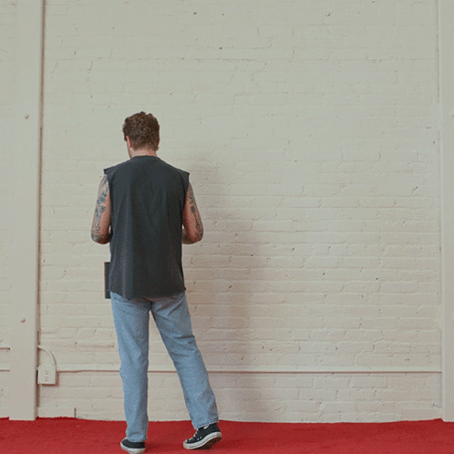A Man Paints A Red Square On A White Wall GIF