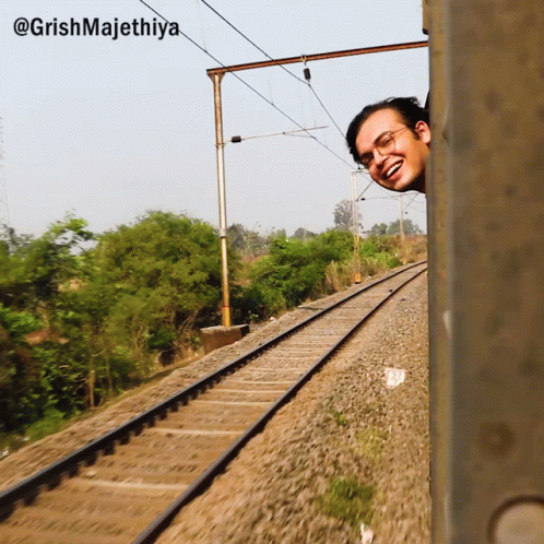 A Man Peeking Out Of A Train Window With The Caption @Grishmajethiya GIF