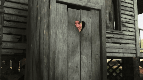 A Man Peeking Out Of A Wooden Door With A Heart Shaped Hole In It GIF