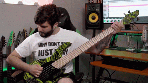 A Man Playing A Bass Guitar With A Shirt That Says Why Don T You Just Play GIF