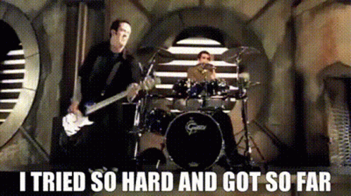 A Man Playing A Guitar And Another Man Playing Drums With The Words I Tried So Hard And Got So Far Below Them GIF