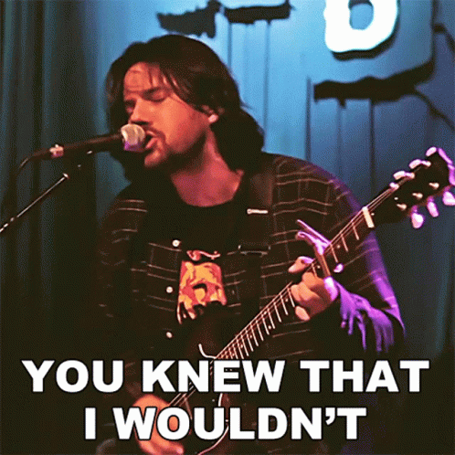 A Man Playing A Guitar And Singing Into A Microphone With The Words " You Knew That I Wouldn 'T " GIF