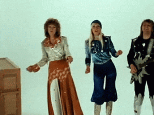 A Man Playing A Guitar And Two Women Dancing In Front Of A White Background GIF