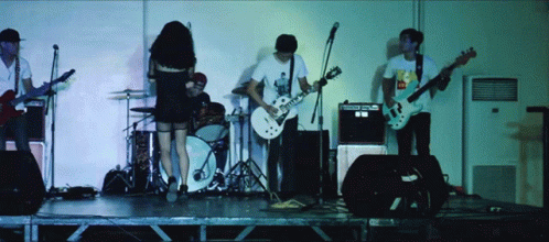 A Man Playing A Guitar Has A Sticker On His Shirt That Says Mcdonalds GIF