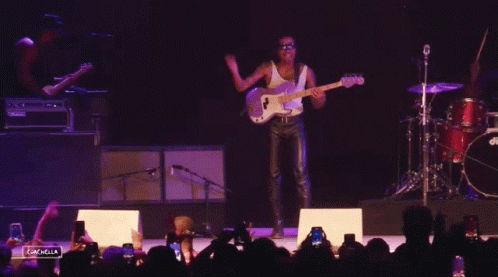 A Man Playing A Guitar In Front Of A Crowd With The Words Coachella Visible GIF