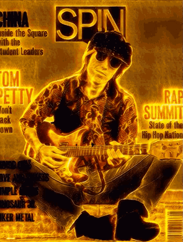 A Man Playing A Guitar On The Cover Of A Magazine Titled Spin GIF
