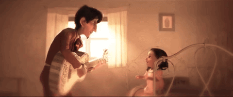 A Man Playing A Guitar To A Little Girl GIF