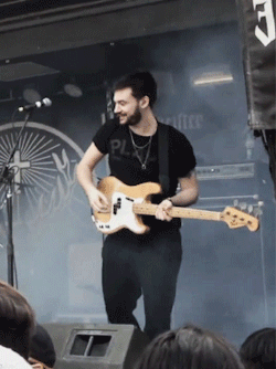 A Man Playing A Guitar With A Shirt That Says Pl GIF