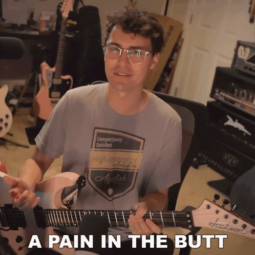 Man Playing Guitar With A Pain In The Butt GIF