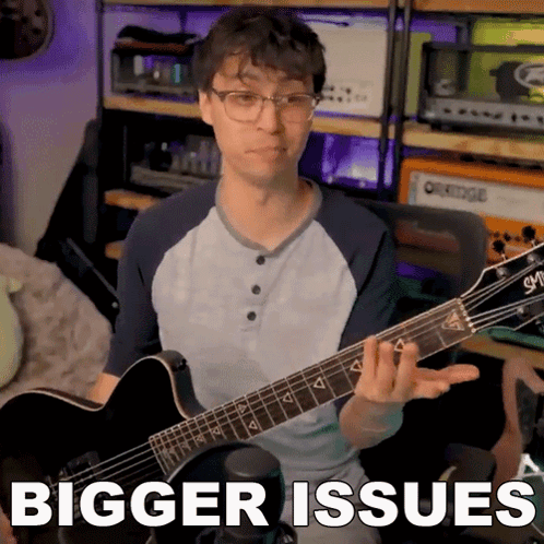 Guitar Player With Bigger Issues Behind Him GIF