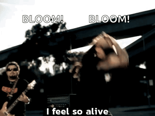 A Man Playing A Guitar With The Words Bloom I Feel So Alive GIF