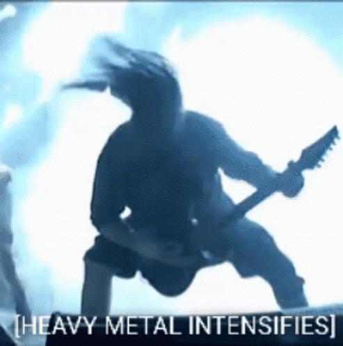 A Man Playing A Guitar With The Words Heavy Metal Intensifies GIF