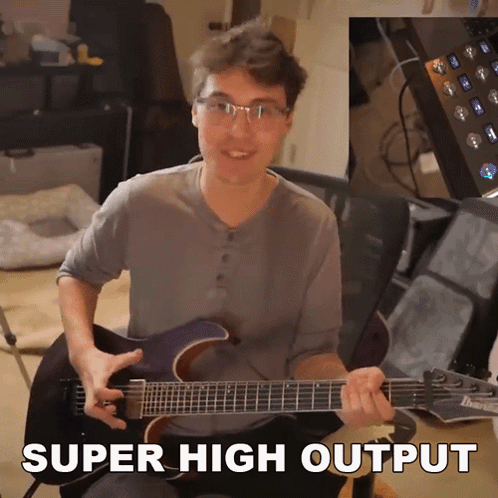 A Man Playing A Guitar With The Words Super High Output Written Below Him GIF