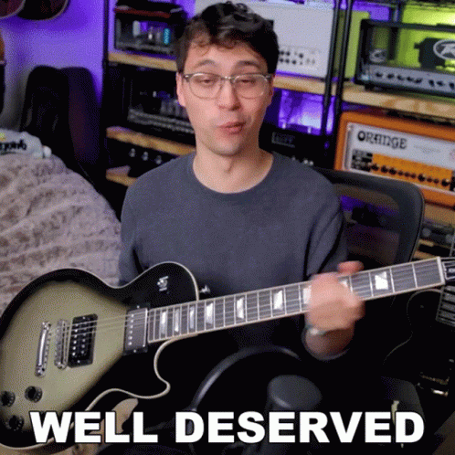 A Man Playing A Guitar With The Words Well Deserved Written Below Him GIF