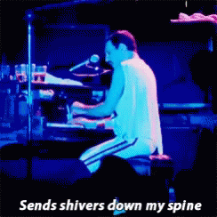 A Man Playing A Piano With The Words " Sends Shivers Down My Spine " Next To Him GIF