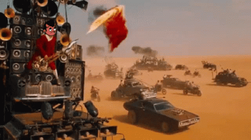 A Man Playing A Saxophone In The Middle Of A Desert With Cars In The Background GIF