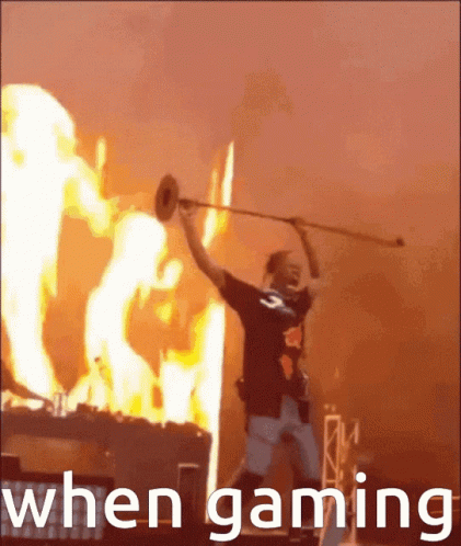A Man Playing A Trumpet In Front Of A Fire With The Words " When Gaming " GIF