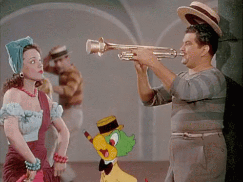 A Man Playing A Trumpet Next To A Woman GIF