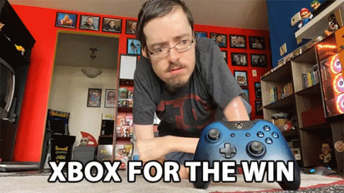 A Man Playing A Video Game With The Words Xbox For The Win Above Him GIF