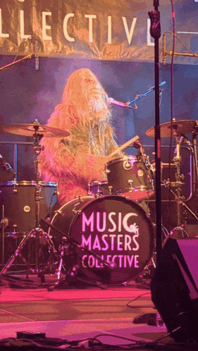 A Man Playing Drums In Front Of A Drum Set That Says Music Masters Collective GIF