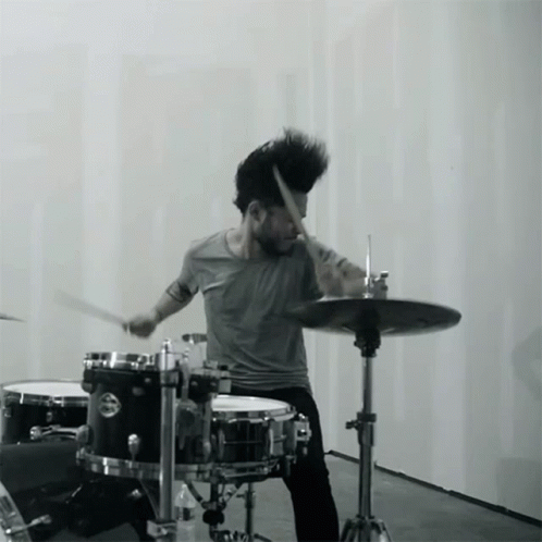 A Man Playing Drums With A Cymbal That Says ' Yamaha ' On It GIF
