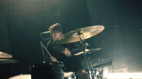 A Man Playing Drums With A Cymbal That Says Zildjian On It GIF