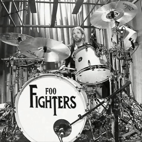 A Man Playing Drums With A Drum Set That Says Foo Fighters On It GIF