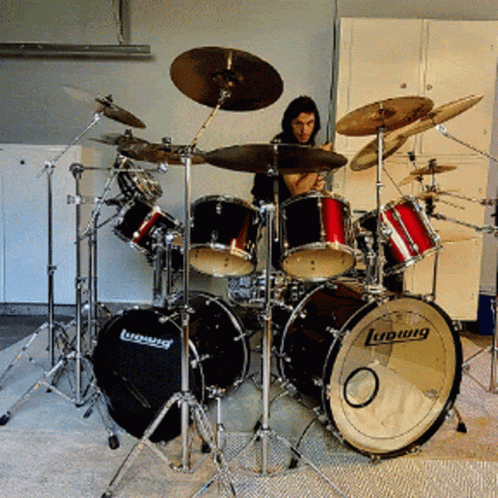 A Man Playing Drums With A Ludwig Drum In The Foreground GIF