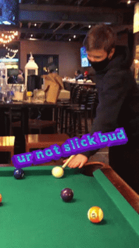 A Man Playing Pool With A Purple Sign That Says Ur Not Slick Bud GIF