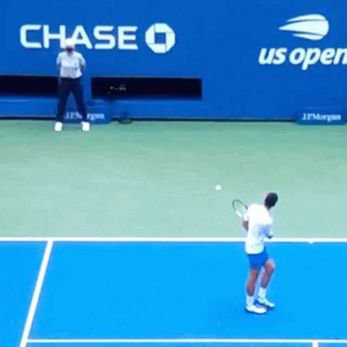 A Man Playing Tennis In Front Of A Chase Advertisement GIF