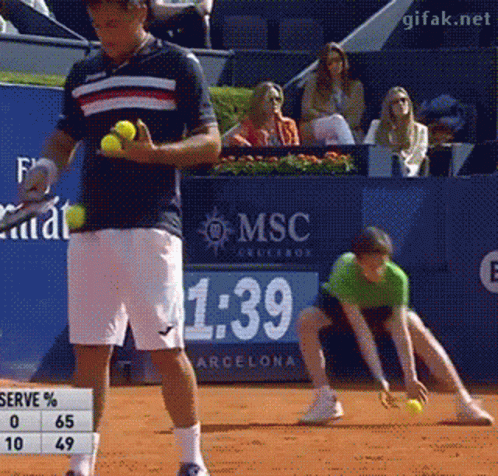 A Man Playing Tennis In Front Of A Sign That Says Msc On It GIF