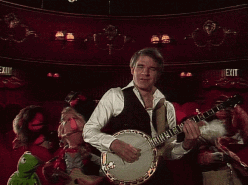 Man Playing Banjo In Front Of Exit Sign GIF