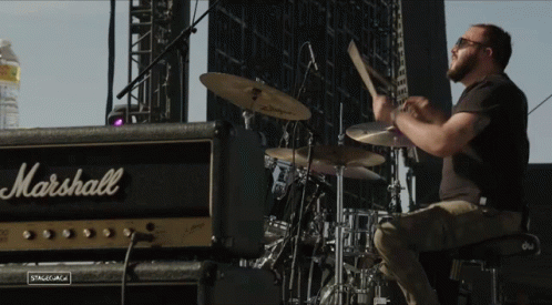 A Man Plays Drums In Front Of A Marshall Amp GIF