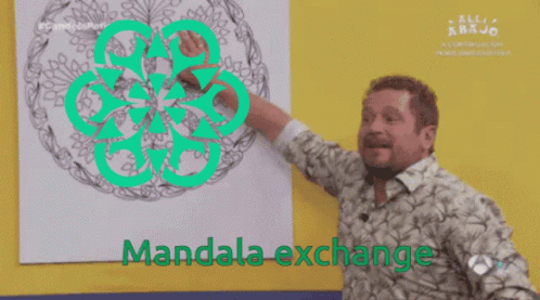 A Man Pointing At A Drawing With The Words Mandala Exchange Above Him GIF