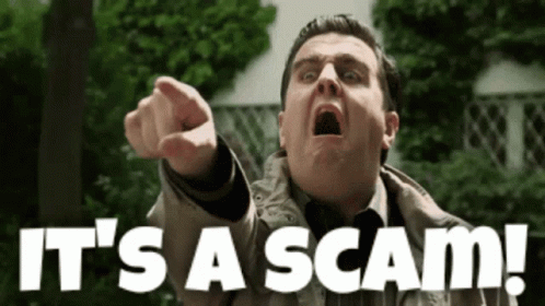 A Man Pointing At The Camera With The Words It 'S A Scam Behind Him GIF