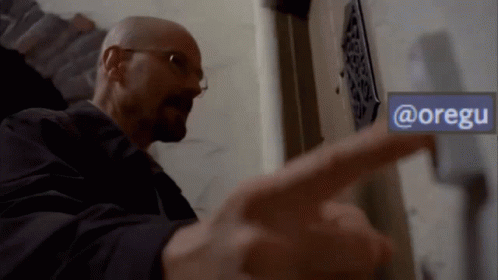 A Man Pointing To A Sign That Says @Oregu GIF