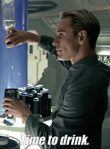 A Man Pouring A Drink Into A Glass With The Words Time To Drink Above Him GIF