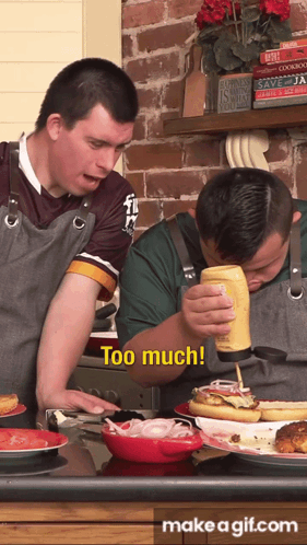 A Man Pouring Mustard On A Hot Dog While Another Man Looks On And Says Too Much GIF