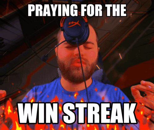 A Man Praying For The Win Streak With Flames Around Him GIF