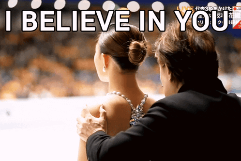 A Man Putting His Hand On A Woman 'S Shoulder With The Words " I Believe In You " Behind Him GIF