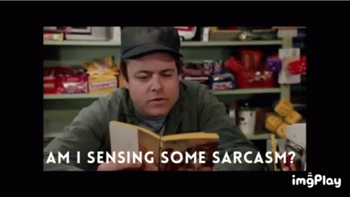 A Man Reading A Book With The Words Am I Sensing Some Sarcasm On The Bottom GIF