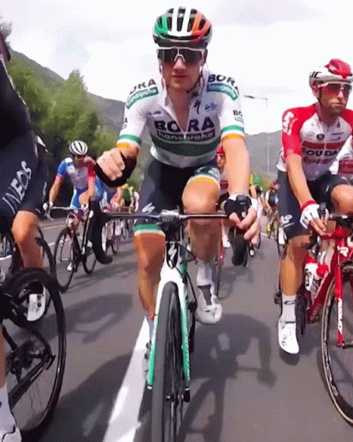 A Man Riding A Bike With Bora Written On His Jersey GIF